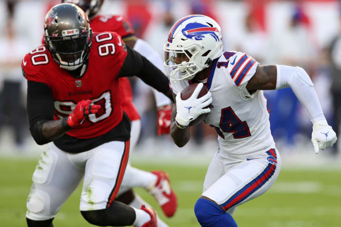 Buffalo Bills wide receiver Stefon Diggs (14) runs away from Tampa Bay Buccaneers linebacker Jason Pierre-Paul (90) after a catch during the first half of an NFL football game Sunday, Dec. 12, 2021, in Tampa, Fla.